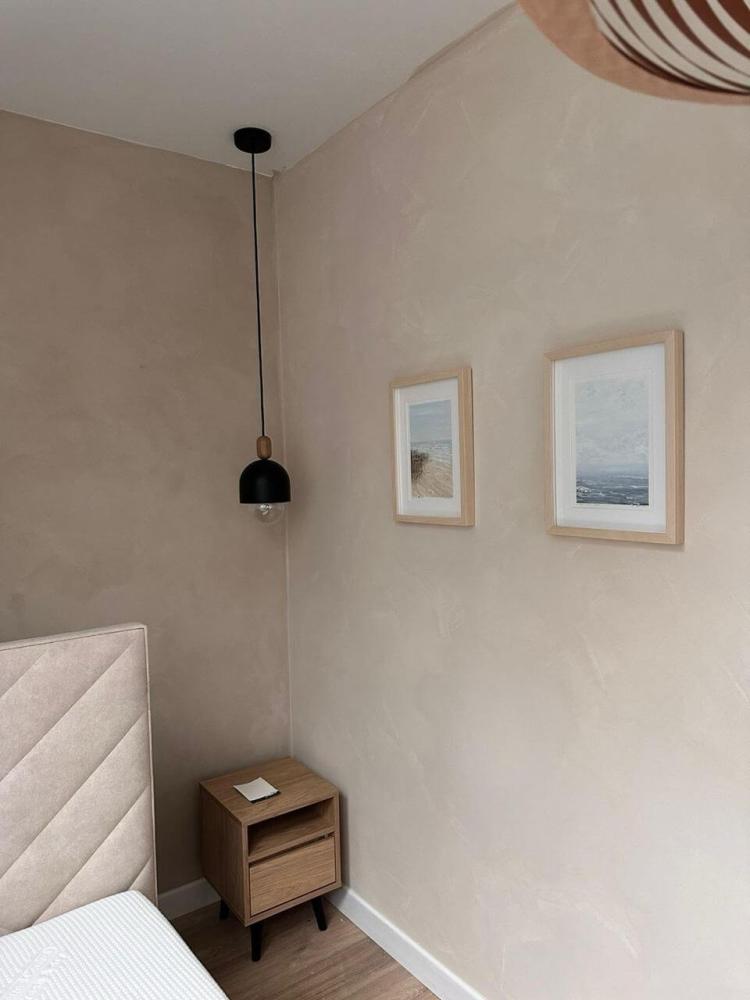 Limewash paint over handcrafted trowel-applied plaster texture